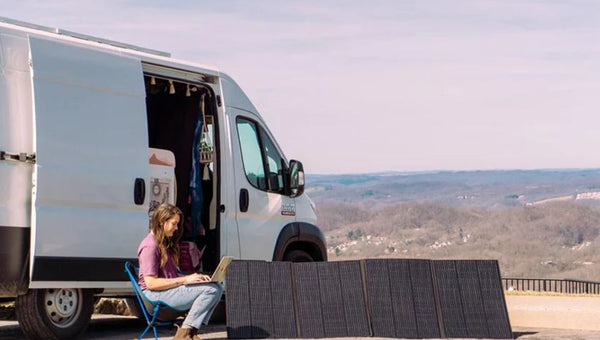 Portable solar panels beside camper van